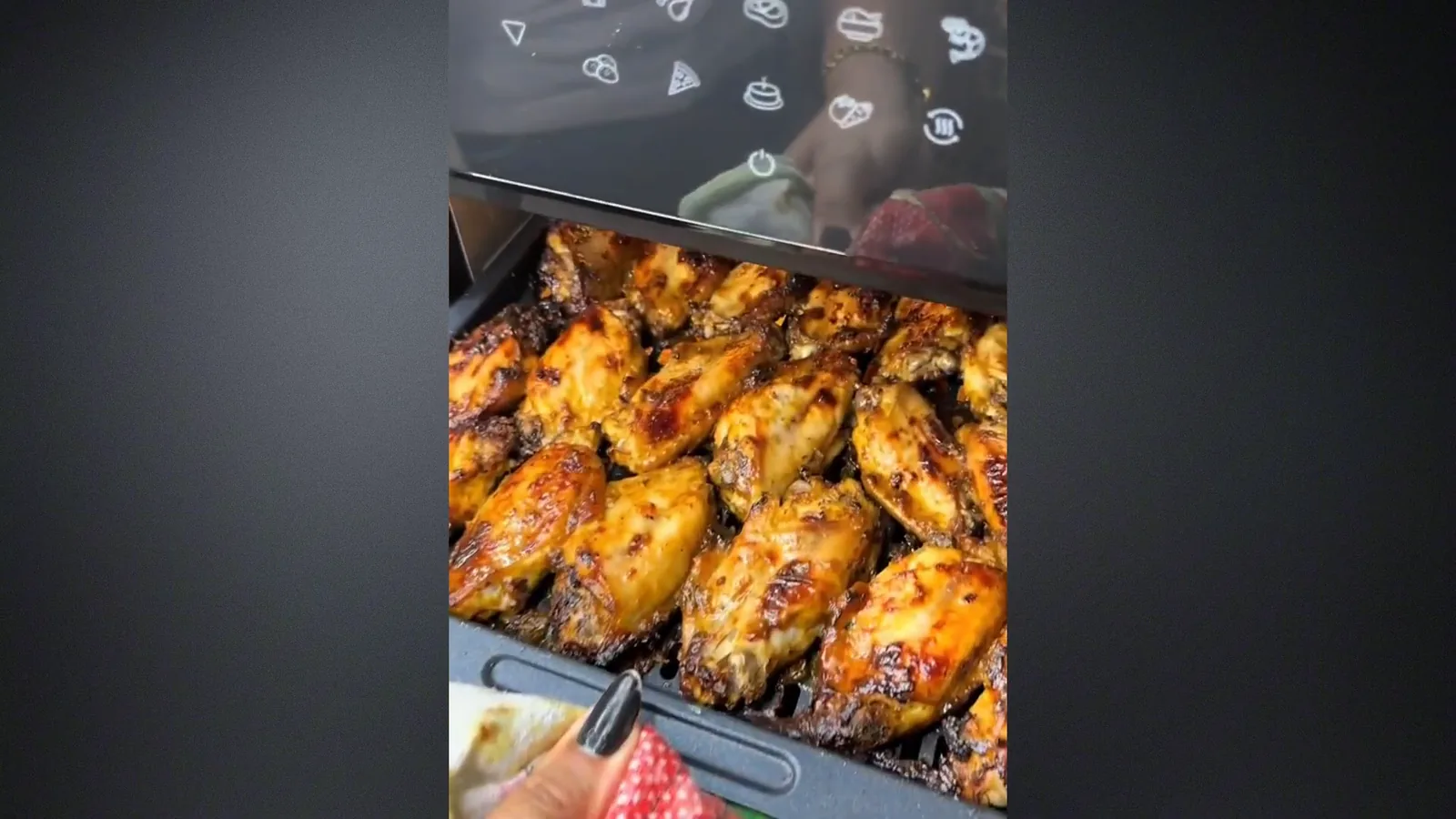 Assadeiras com asas de frango e batatas dentro do forno