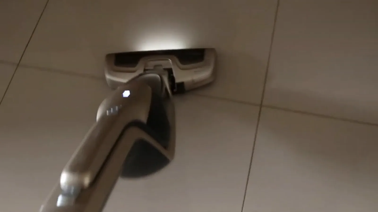 Aspirador vertical Electrolux em funcionamento sobre piso de porcelanato