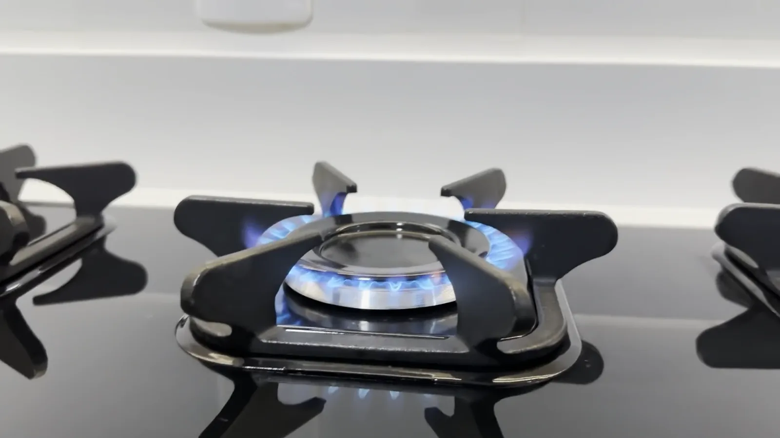 Queimador central aceso com chama forte no cooktop Mueller Unica