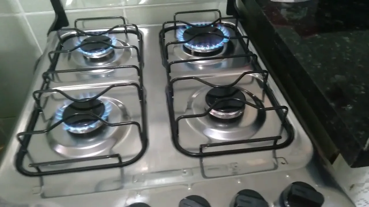 Quatro queimadores acesos da mesa de inox em funcionamento simultâneo