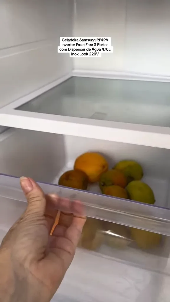 Gaveta de frutas e vegetais sendo aberta no refrigerador