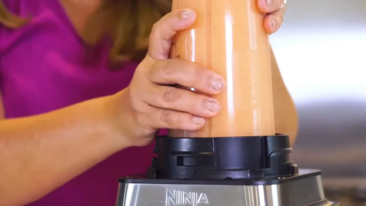 Liquidificador batendo smoothie cremoso diretamente no copo individual