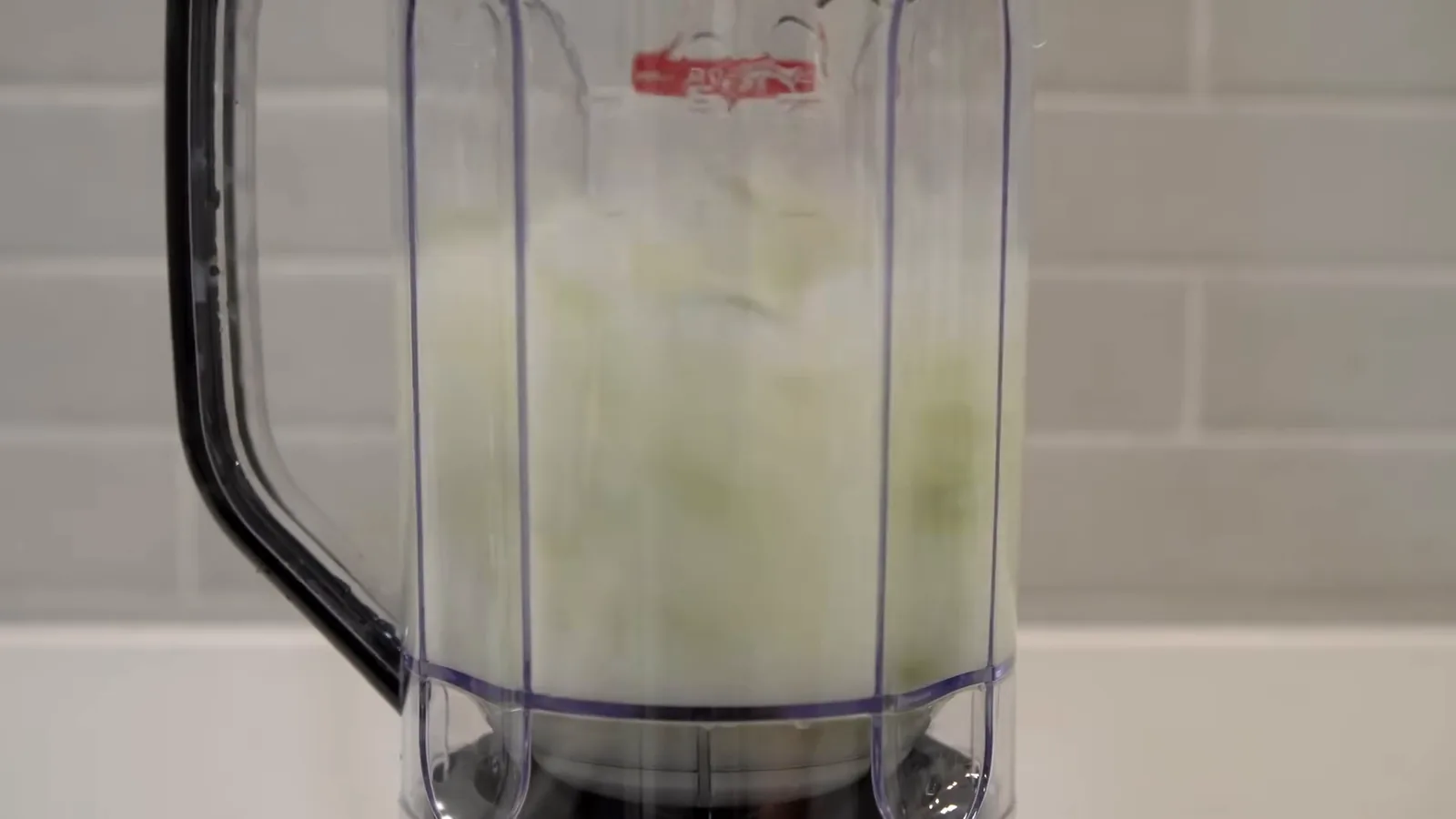 Liquidificador Mondial triturando limão com água dentro do copo