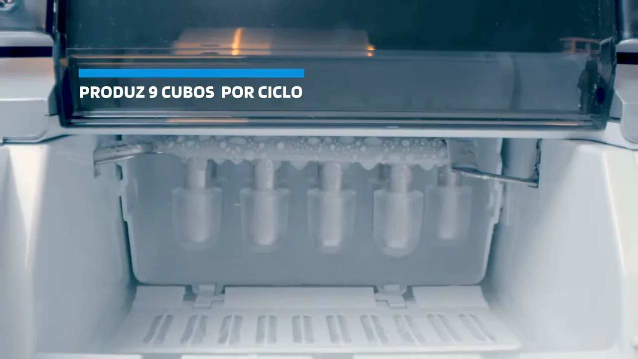 Mecanismo interno em funcionamento produzindo e soltando cubos de gelo