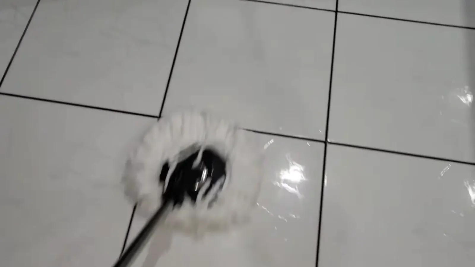 Refil de microfibra limpando o piso cerâmico com passadas suaves
