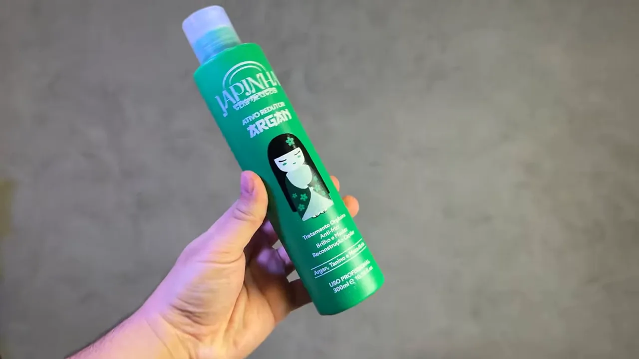 Frasco do ativo redutor da Japinha sendo manuseado com detalhes