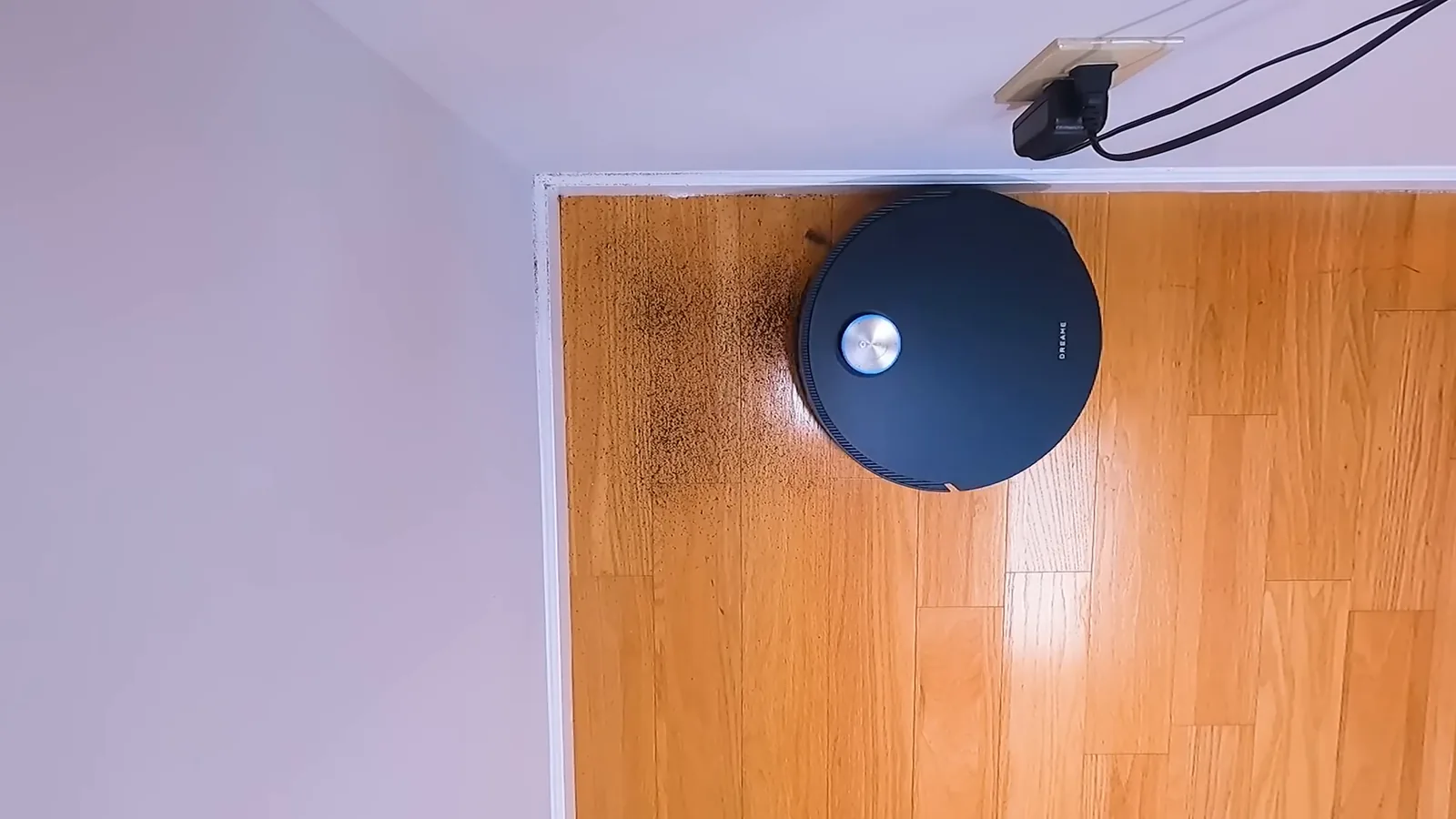 Robô aspirador alcança cantos com escova lateral extensível em piso de madeira