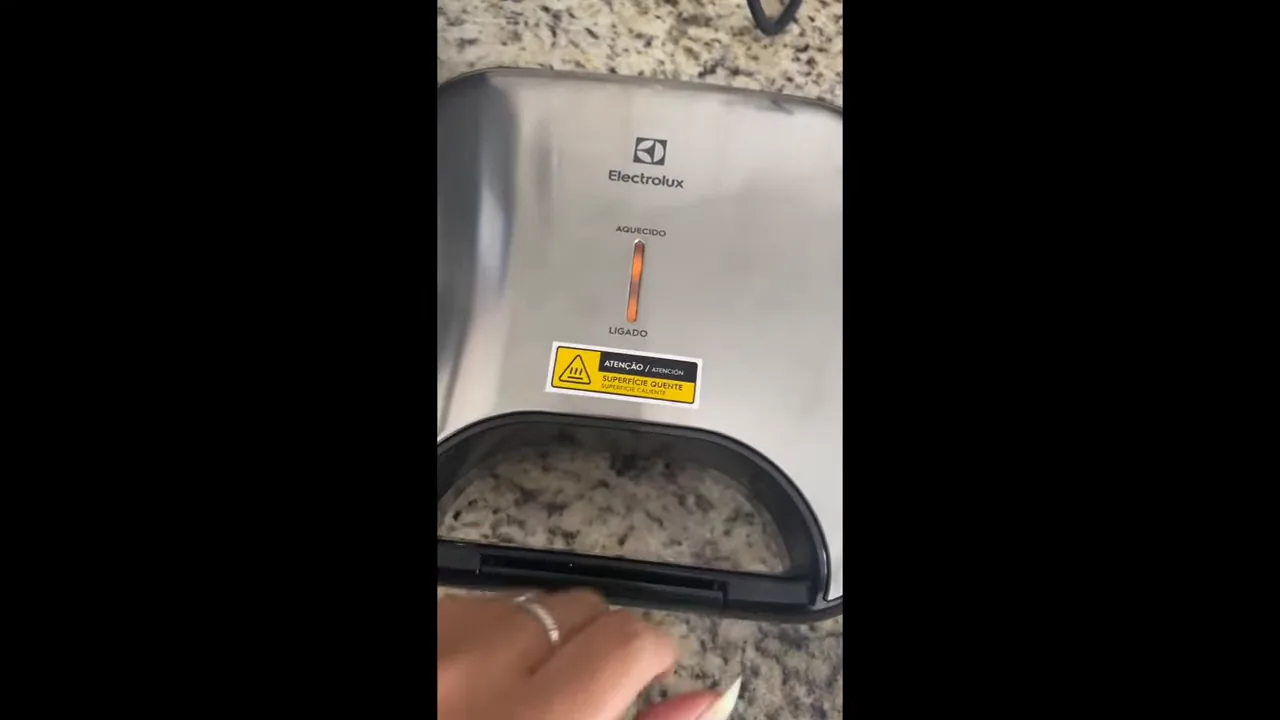 Abertura da sanduicheira Electrolux revelando o sanduíche perfeitamente tostado