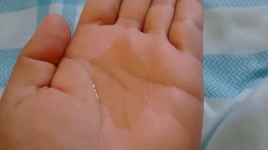 Textura transparente e fluida do shampoo antirresíduos na palma da mão