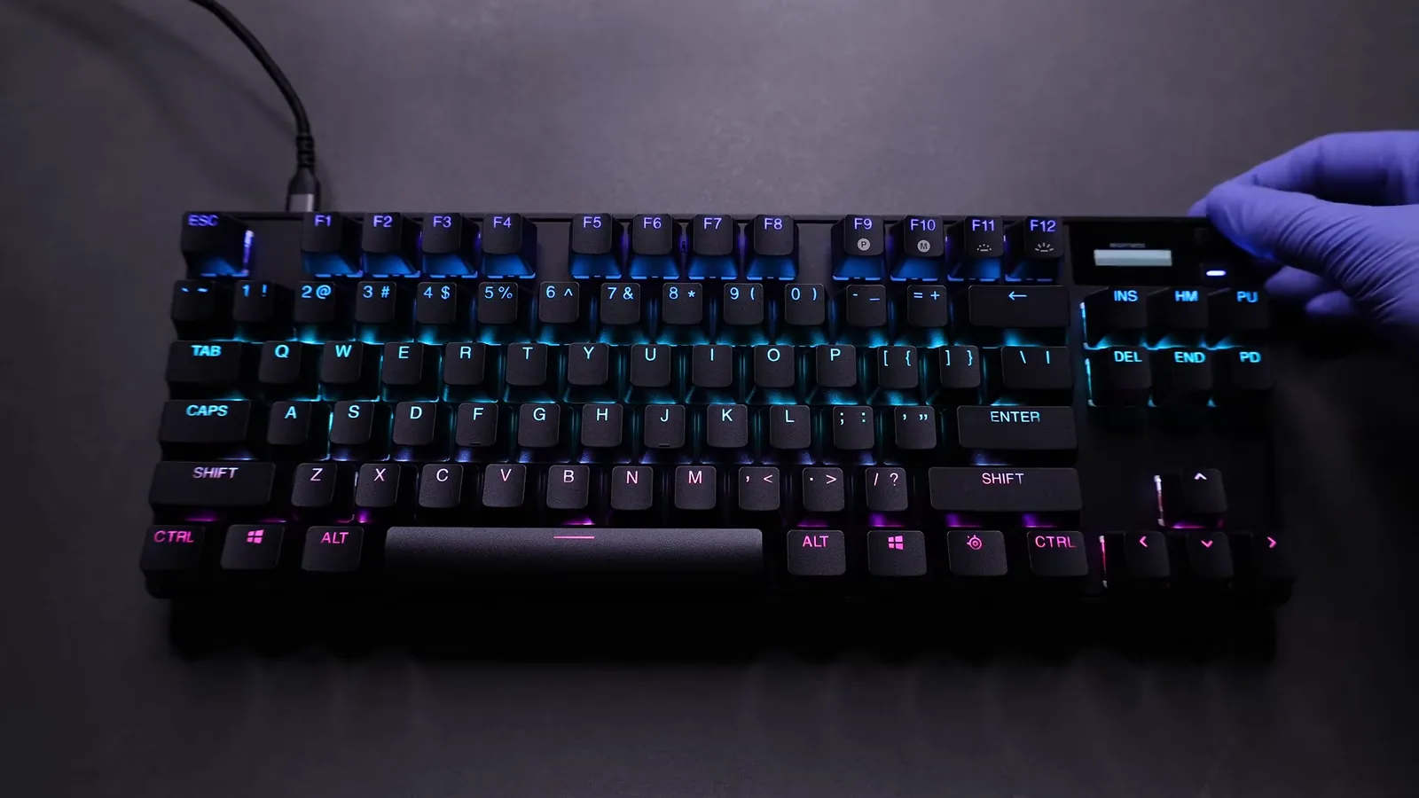 Teclado gamer com iluminação RGB dinâmica ativada sobre a mesa